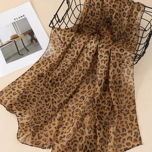 Close-up of leopard print chiffon scarf with brown tones and lightweight texture