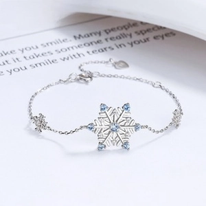 Detail of S925 silver snowflake bracelet with blue gemstone inlay and extension chain