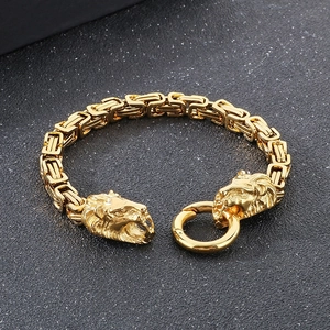 Detailed view of gold Byzantine chain bracelet with intricately carved lion head clasps