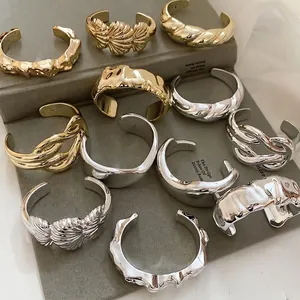 Minimalist irregular textured cuff bracelets in gold and silver finish with lava design