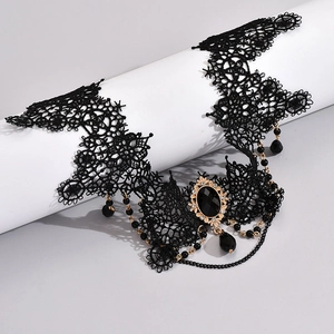 Macro shot of dark gothic lace choker featuring a black oval gemstone and bead tassel
