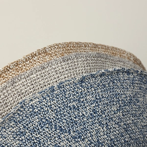 Detail of handmade crochet straw hat edges showing beige, grey and blue woven texture