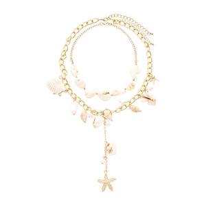Layered gold chain necklace featuring seashell charms and starfish pearls on white background