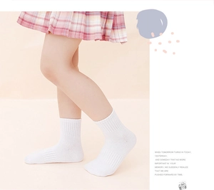 Detailed side view of white cotton mid-calf socks with vertical ribbed knit pattern