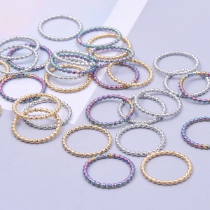Polished stainless steel beaded rings in gold, silver, and rainbow plating