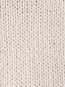 Detailed macro shot of cream-colored asymmetric knit fabric with thick woven texture
