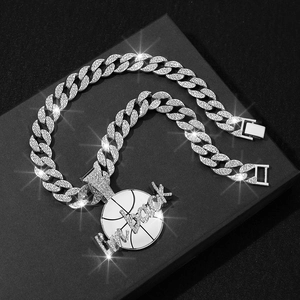 Close-up of iced out basketball pendant with I'm back lettering on silver Cuban link chain