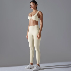Detail of cream yoga set with twist-front sports bra and high-waist leggings