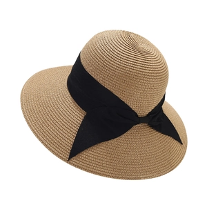 Elegant khaki straw sun hat for women featuring a wide brim and black ribbon bow detail