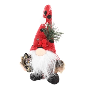 Christmas gnome plush with red knitted hat holding a pine branch and vintage lantern