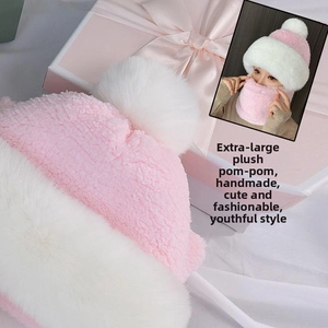 Detail of soft pink and white coral fleece knit hat with a large plush pompom
