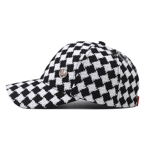Classic black and white houndstooth baseball cap with a silver metal M logo badge
