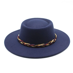 Top view of dark blue wool fedora hat with wide brim and multicolor braided band detail