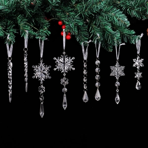 Clear acrylic snowflake and icicle ornaments hanging on a Christmas tree branch