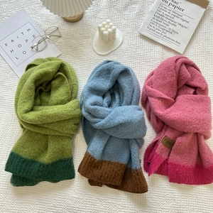 Close-up of soft cashmere-like knitted scarves with two-tone color block design details