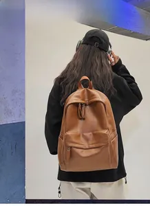 Detailed back view of a brown leather laptop backpack with sturdy shoulder straps