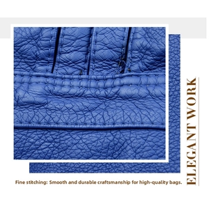 Detail of elegant blue lychee pattern leather with delicate stitching on backpack