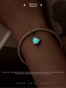 Détail macro d'un bracelet coquillage en argent avec perle lumineuse et bords en cristal