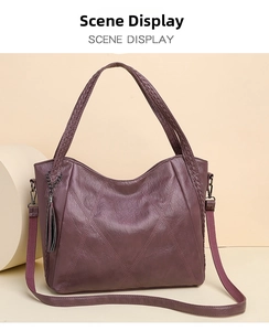 Detail of a deep purple faux leather handbag with vintage texture and woven handle