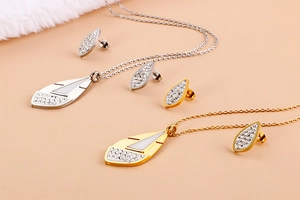 Detail of feather-shaped gold and silver jewelry sets with sparkling rhinestones