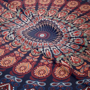 Close-up of mandala and paisley textile fabric with detailed blue and orange patterns