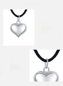 Macro view of polished s925 silver heart pendant with black cord and mirror finish