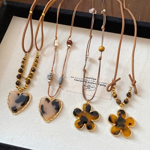 Vintage wood bead necklace with tiger eye stone and resin flower pendant on leather cord