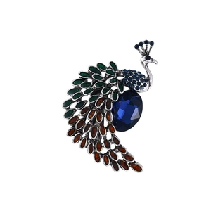 Vintage peacock brooch in silver alloy with vibrant rhinestones and blue gemstone