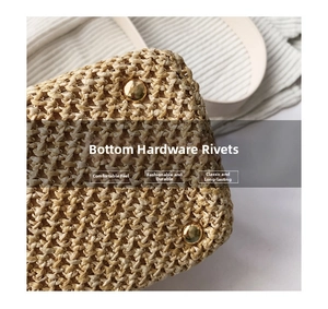 Detailed macro view of woven straw bag bottom with golden metal protective rivets