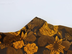 Detail of vintage black and gold jacquard fabric and Chinese mandarin collar design