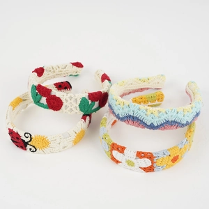 Detailed close-up of four handmade crochet headbands with floral and cherry patterns