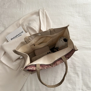 Ethnic style woven linen tote bag with geometric print and spacious interior for daily essentials