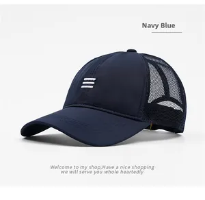 Detail of navy blue mesh baseball cap with breathable fabric and white embroidery