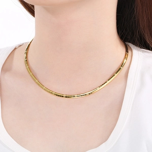 Close-up of a minimalist 8mm gold stainless steel choker necklace on a female model