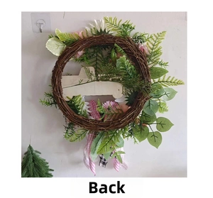 Detailed back view of pink floral wreath with natural rattan base and festive ribbons