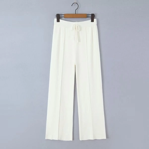 Detailed view of white ribbed knit fabric texture and elastic drawstring waistband
