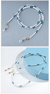 Detail of beaded eyewear chain with blue and white beads and golden lobster clasps