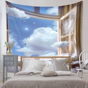 Detail of bohemian wall tapestry featuring moon and clouds for bedroom wall decor