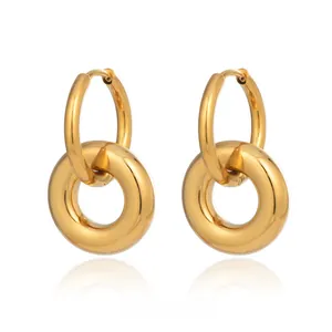 Detail of interlocking golden stainless steel hoop earrings with high polish finish