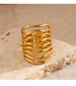 Detail of 18K gold-plated stainless steel wide ring with hammer texture on natural stone