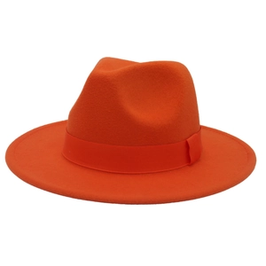 Detail of orange fedora hat featuring wide brim and matching decorative ribbon band