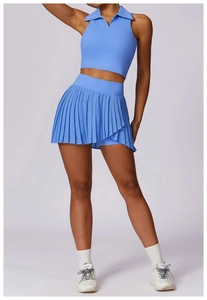 Detail of a light blue sleeveless polo sports top and pleated tennis skirt set for women