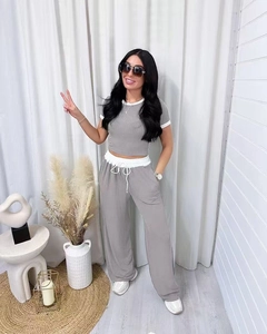 Close-up of gray ribbed short sleeve crop top and wide leg pants with white contrast trim