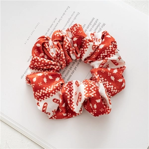 Detail of red and white Christmas scrunchie with snowflakes on a vintage book