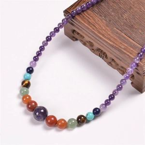 Close-up of 6mm natural amethyst and multicolored stone beads with gradient size design