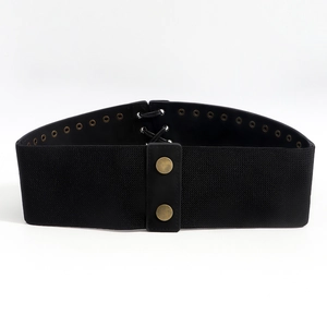 Detail of black corset belt with lace-up back design and bronze snap buttons