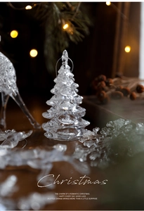 Detail of crystal acrylic Christmas tree ornament with glitter flakes and reindeer decor