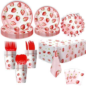 Strawberry theme party tableware set with paper plates cups and napkins on white backdrop
