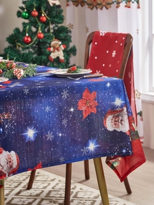 Close-up of navy blue Christmas tablecloth and chair covers with Santa Claus and snowflake prints