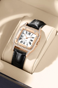 Detail view of square rose gold watch with crystal bezel and black Roman numeral dial